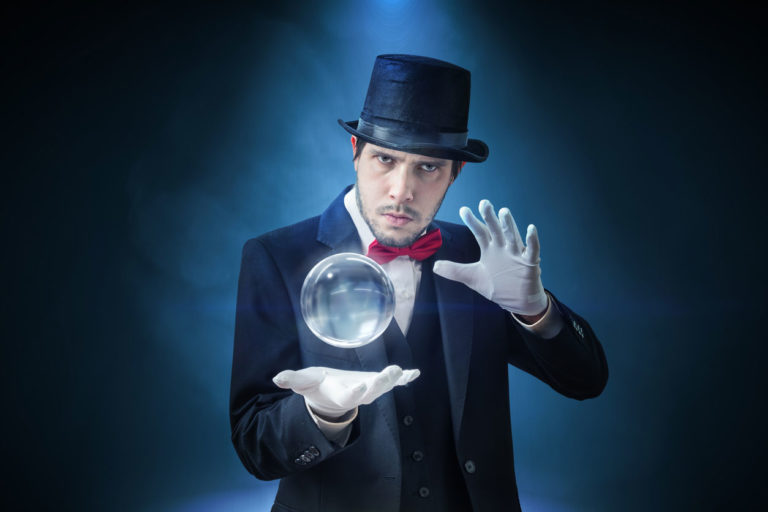 Magician levitating a ball while wearing a magician outfit